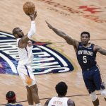 Phoenix Suns guard Chris Paul (3) shoots a three point basket over New Orleans Pelicans guard Eric Bledsoe (5) in the third quarter of an NBA basketball game in New Orleans, Wednesday, Feb. 3, 2021. (AP Photo/Derick Hingle)