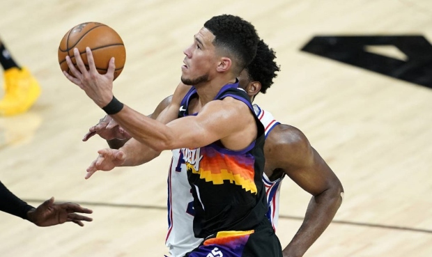 Phoenix Suns guard Devin Booker (1) shoots against Philadelphia 76ers during the second half of an ...