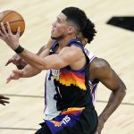Phoenix Suns guard Devin Booker (1) shoots against Philadelphia 76ers during the second half of an NBA basketball game, Saturday, Feb. 13, 2021, in Phoenix.(AP Photo/Matt York)