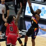 Phoenix Suns guard Chris Paul, right, shoots over Chicago Bulls guard Coby White during the second half of an NBA basketball game in Chicago, Friday, Feb. 26, 2021. (AP Photo/Nam Y. Huh)