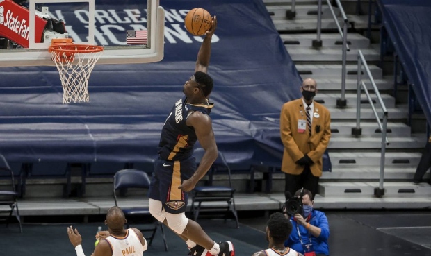 New Orleans Pelicans forward Zion Williamson (1) dunks past Phoenix Suns center Deandre Ayton (22) ...