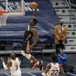 New Orleans Pelicans forward Zion Williamson (1) dunks past Phoenix Suns center Deandre Ayton (22) and guard Chris Paul (3) in the fouirth quarter of an NBA basketball game in New Orleans, Wednesday, Feb. 3, 2021. (AP Photo/Derick Hingle)