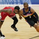 Phoenix Suns guard Chris Paul, right, drives against Chicago Bulls guard Coby White during the first half of an NBA basketball game in Chicago, Friday, Feb. 26, 2021. (AP Photo/Nam Y. Huh)