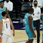 Phoenix Suns guard Devin Booker (1) has words with Charlotte Hornets guard LaMelo Ball, right, during the second half of an NBA basketball game, Wednesday, Feb. 24, 2021, in Phoenix. Booker was given a technical foul for the confrontation. (AP Photo/Matt York)