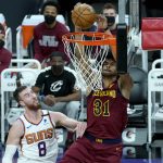 Cleveland Cavaliers center Jarrett Allen (31) shoots over Phoenix Suns forward Frank Kaminsky (8) during the first half of an NBA basketball game, Monday, Feb. 8, 2021, in Phoenix. (AP Photo/Matt York)