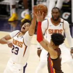 Phoenix Suns' Cam Johnson (23) goes for the block against Portland Trail Blazers' Anfernee Simons during the second half of an NBA basketball game Monday, Feb. 22, 2021, in Phoenix. (AP Photo/Darryl Webb)
