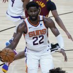 Phoenix Suns center Deandre Ayton (22) looks to pass against the Cleveland Cavaliers during the second half of an NBA basketball game, Monday, Feb. 8, 2021, in Phoenix. (AP Photo/Matt York)