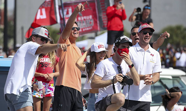 Tampa Bay Buccaneers NFL football quarterback Tom Brady, second from left, gesture as he and others...