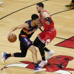 Phoenix Suns guard Devin Booker, left, drives against Chicago Bulls guard Zach LaVine during the first half of an NBA basketball game in Chicago, Friday, Feb. 26, 2021. (AP Photo/Nam Y. Huh)