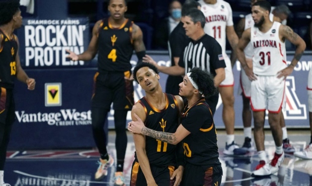 Arizona State guard Alonzo Verge Jr. (11) is held by guard Jaelen House (10) after getting a foul c...