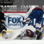 Colorado Avalanche goaltender Hunter Miska slides along the ice to make a save a shot from Arizona Coyotes center Drake Caggiula (91) as Avalanche defenseman Devon Toews, right, falls over Miska during the second period of an NHL hockey game Friday, Feb. 26, 2021, in Glendale, Ariz. (AP Photo/Ross D. Franklin)