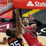 Chicago Bulls guard Zach LaVine, right, drives to the basket against Phoenix Suns forward Mikal Bridges during the second half of an NBA basketball game in Chicago, Friday, Feb. 26, 2021. (AP Photo/Nam Y. Huh)