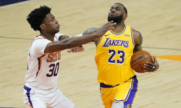 Phoenix Suns center Damian Jones (30) defends against Los Angeles Lakers forward LeBron James (23) ...