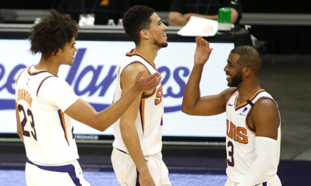 Phoenix Suns' Cam Johnson (23) Devin Booker (1) and Chris Paul (3) celebrate Johnson's last-second ...