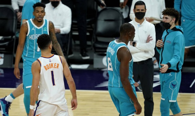 Phoenix Suns guard Devin Booker (1) has words with Charlotte Hornets guard LaMelo Ball, right, duri...