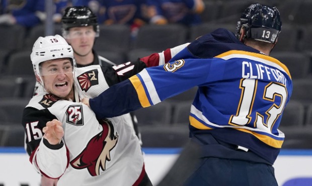Arizona Coyotes' John Hayden (15) and St. Louis Blues' Kyle Clifford (13) fight during the first pe...