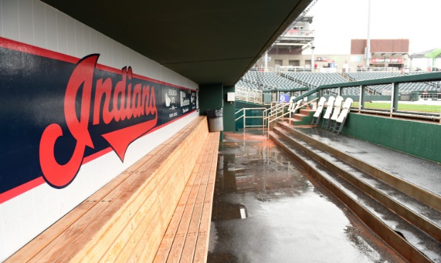 Water covers an empty Cleveland Indians dugout during a rain delay prior to a spring training game ...