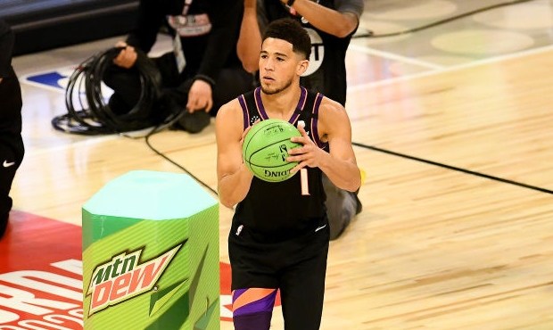 Devin Booker #1 of the Phoenix Suns attempts a shot in the 2020 NBA All-Star - MTN DEW 3-Point Cont...