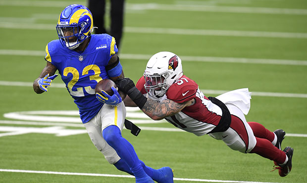 Tanner Vallejo #51 of the Arizona Cardinals attempts to tackle Cam Akers #23 of the Los Angeles Ram...
