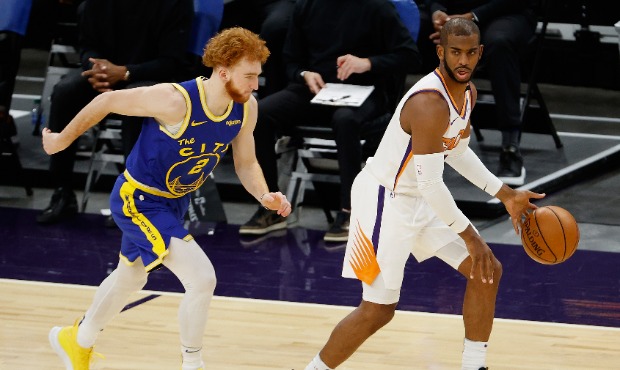 Chris Paul #3 of the Phoenix Suns handles the ball ahead of Nico Mannion #2 of the Golden State War...