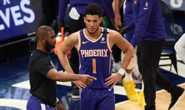 Chris Paul #3 and Devin Booker #1 of the Phoenix Suns speak in a timeout during the second quarter ...
