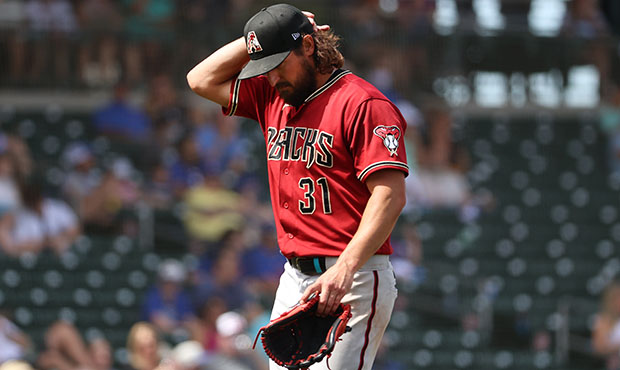 Caleb Smith #31 of the Arizona Diamondbacks reacts while exiting the game in the fourth inning afte...