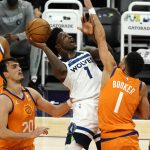 Minnesota Timberwolves forward Anthony Edwards, front center, drives between Phoenix Suns forward Mikal Bridges (25), forward Dario Saric (20), and guard Devin Booker, right, during the first half of an NBA basketball game Friday, March 19, 2021, in Phoenix. (AP Photo/Rick Scuteri)