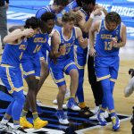 UCLA players celebrate after an Elite 8 game against Michigan in the NCAA men's college basketball tournament at Lucas Oil Stadium, Wednesday, March 31, 2021, in Indianapolis. UCLA won 51-49. (AP Photo/Darron Cummings)