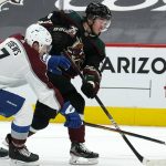 Arizona Coyotes right wing Clayton Keller shoots on Colorado Avalanche defenseman Devon Toews (7) during the second period of an NHL hockey game Monday, March 22, 2021, in Glendale, Ariz. (AP Photo/Rick Scuteri)
