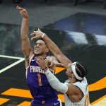 
              Phoenix Suns guard Devin Booker (1) takes a shot over Orlando Magic forward Aaron Gordon, right, during the first half of an NBA basketball game, Wednesday, March 24, 2021, in Orlando, Fla. (AP Photo/John Raoux)
            