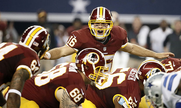 Washington Redskins' Colt McCoy instructs the line of scrimmage during the first half of an NFL foo...