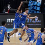 UCLA players celebrate after beating Michigan 51-49 in an Elite 8 game in the NCAA men's college basketball tournament at Lucas Oil Stadium, Wednesday, March 31, 2021, in Indianapolis. (AP Photo/Michael Conroy)