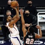 Phoenix Suns forward Mikal Bridges shoots over Memphis Grizzlies guard Desmond Bane (22) during the first half of an NBA basketball game Monday, March 15, 2021, in Phoenix. (AP Photo/Rick Scuteri)