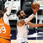 Minnesota Timberwolves guard Ricky Rubio, right, drives past Phoenix Suns forward Jae Crowder (99) during the first half of an NBA basketball game Friday, March 19, 2021, in Phoenix. (AP Photo/Rick Scuteri)