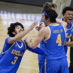 UCLA guard Johnny Juzang (3) and guard Jaime Jaquez Jr. (4) celebrate after an Elite 8 game against Michigan in the NCAA men's college basketball tournament at Lucas Oil Stadium, Wednesday, March 31, 2021, in Indianapolis. UCLA won 51-49. (AP Photo/Darron Cummings)