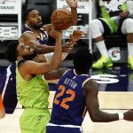 Minnesota Timberwolves center Karl-Anthony Towns (32) , center, fights for the ball with Phoenix Suns guard Chris Paul (3) and center Deandre Ayton (22) during the first half of an NBA basketball game Thursday, March 18, 2021, in Phoenix. (AP Photo/Rick Scuteri)