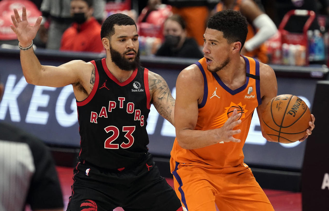 Phoenix Suns guard Devin Booker (1) controls the ball in front of Toronto Raptors guard Fred VanVle...