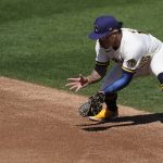 Milwaukee Brewers second baseman Kolten Wong fields a ground ball hit by Arizona Diamondbacks' Ketel Marte during the second inning of a spring training baseball game Friday, March 19, 2021, in Phoenix. (AP Photo/Ashley Landis)