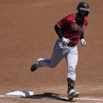 Arizona Diamondbacks' Christian Walker runs the bases after hitting a home run during the first inning of a spring training baseball game against the Milwaukee Brewers Friday, March 19, 2021, in Phoenix. (AP Photo/Ashley Landis)