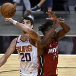 Phoenix Suns forward Dario Saric (20) tips the ball away from Miami Heat forward Jimmy Butler (22) during the second half of an NBA basketball game Tuesday, March 23, 2021, in Miami. (AP Photo/Jim Rassol)