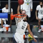 
              Oregon's LJ Figueroa (12) dunks against Arizona State during the second half of an NCAA college basketball game in the quarterfinal round of the Pac-12 men's tournament Thursday, March 11, 2021, in Las Vegas. (AP Photo/John Locher)
            