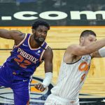 Orlando Magic center Nikola Vucevic, right, grabs a pass that was over the head of Phoenix Suns center Deandre Ayton (22) during the second half of an NBA basketball game, Wednesday, March 24, 2021, in Orlando, Fla. (AP Photo/John Raoux)