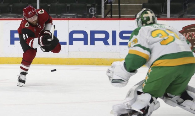 Arizona Coyotes' Phil Kessel (81) shoots the puck at Minnesota Wild's goalie Cam Talbot (33) during...