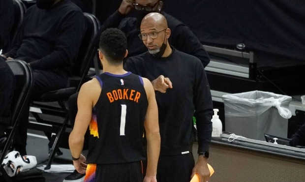Phoenix Suns head coach Monty Williams talks to guard Devin Booker (1) during the second half of an...