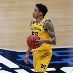 Michigan guard Eli Brooks drives up court during the second half of an Elite 8 game against UCLA in the NCAA men's college basketball tournament at Lucas Oil Stadium, Tuesday, March 30, 2021, in Indianapolis. (AP Photo/Michael Conroy)