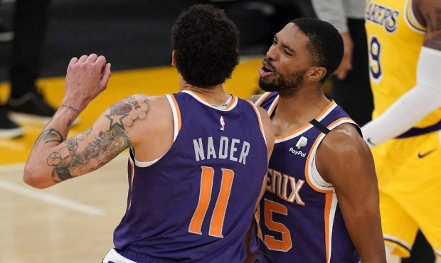 Phoenix Suns forward Abdel Nader, left, celebrates after scoring with forward Mikal Bridges during ...