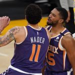 Phoenix Suns forward Abdel Nader, left, celebrates after scoring with guard Cameron Payne during the second half of an NBA basketball game against the Los Angeles Lakers Tuesday, March 2, 2021, in Los Angeles. The Suns won 114-104. (AP Photo/Mark J. Terrill)