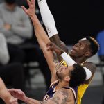 Los Angeles Lakers guard Dennis Schroder, right, shoots as Phoenix Suns forward Abdel Nader defends during the second half of an NBA basketball game Tuesday, March 2, 2021, in Los Angeles. The Suns won 114-104. (AP Photo/Mark J. Terrill)