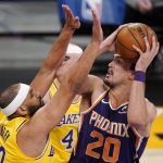 Phoenix Suns forward Dario Saric, right, shoots as Los Angeles Lakers forward Jared Dudley defends during the first half of an NBA basketball game Tuesday, March 2, 2021, in Los Angeles. (AP Photo/Mark J. Terrill)
