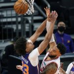Chicago Bulls guard Denzel Valentine, right, gets a pass off as Phoenix Suns forward Cameron Johnson (23) defends during the first half of an NBA basketball game Wednesday, March 31, 2021, in Phoenix. (AP Photo/Ross D. Franklin)